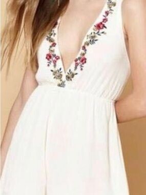 Kendall & Kylie white floral embroidered jumpsuit with pink, red, and green flow